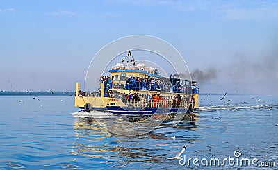 Small tourist ship with the passengers. Beautiful seascape with a tourist boat. The ferry just left the pier. Editorial Stock Photo