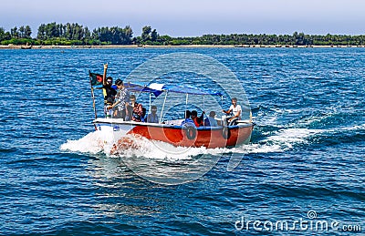 Small tourist ship with the passengers. Beautiful seascape with a tourist boat. The ferry just left the pier. Editorial Stock Photo