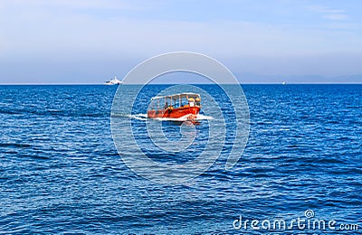 Small tourist ship with the passengers. Beautiful seascape with a tourist boat. The ferry just left the pier. Editorial Stock Photo