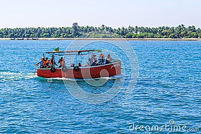 Small tourist ship with the passengers. Beautiful seascape with a tourist boat. The ferry just left the pier. Editorial Stock Photo