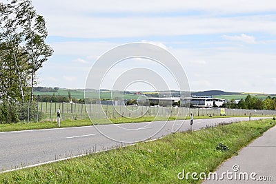 Mendig, Germany - 04 15 2024: Airfield Flugplatz Mendig with the passign road Editorial Stock Photo