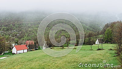 The small town between the mountains. Morning. Fog. Mist. Smog. Montenegro village houses and green landscape Stock Photo