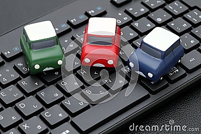 Small toy car on computer keyboard Stock Photo
