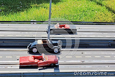 Small toys cars on a road near grass Stock Photo