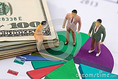 Small toys people discuss the schedule and dollars Stock Photo