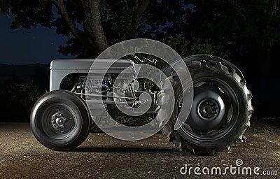 Small Tractor at Night Stock Photo