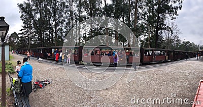 Small train station in Mordos Bay, passing trains, many people Editorial Stock Photo