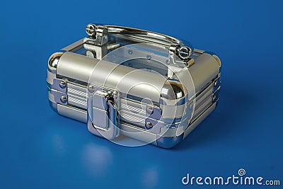 A small transparent closed suitcase on a blue background Stock Photo