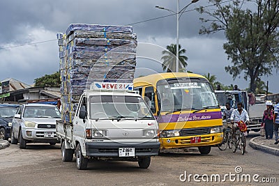 A small truck carries a bunch of mattresses on a busy street of Zanzibar island, Tanzania, East Africa Editorial Stock Photo