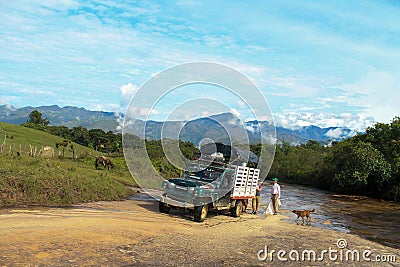 Small truck crossing the Las Gachas river, where we managed to notice the Colombian peasant tradition Editorial Stock Photo