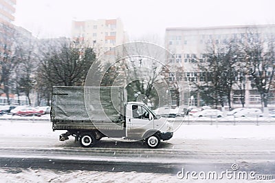 Small truck driving in winter Stock Photo