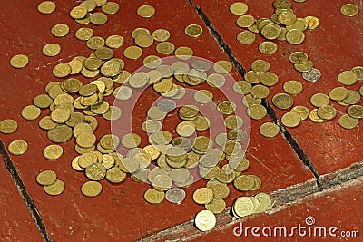 Small Ukrainian coins are scattered on the wooden floor. Stock Photo