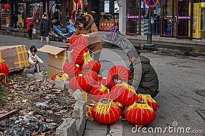 Small vendor who is assembling red lanterns Editorial Stock Photo