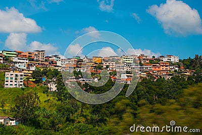 Small villages on the road to Rio de Janeiro. Beautiful landscape overlooking fields and hills with white clouds and blue sky. Stock Photo