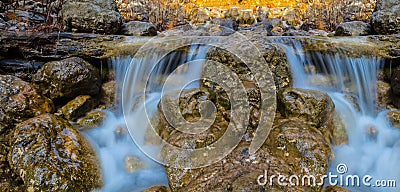 Small waterfall on a river rushing ower the stones Stock Photo