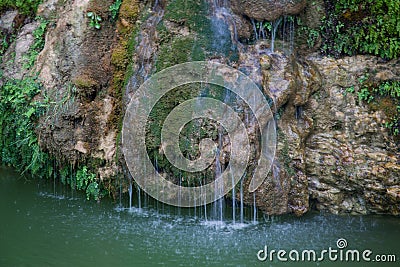 Small waterfall sliding over stone and moss Stock Photo