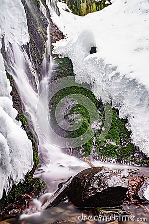 Small waterfall winter snow ice frost cold nature water mountains Stock Photo