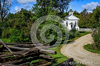 Small White Country Church with Rustic Fence Stock Photo