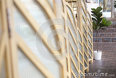 small white plant pot with artificial leaves blur foreground of room partition Stock Photo