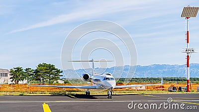 Small white private jet parked in airport Stock Photo