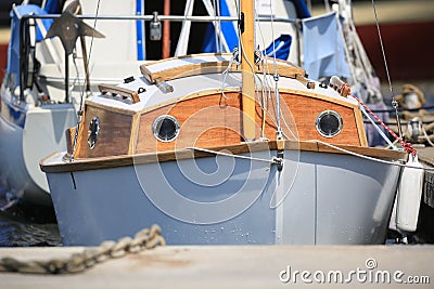 Small white sailing yacht with wooden deckhouse on a sunny day, close-up Stock Photo