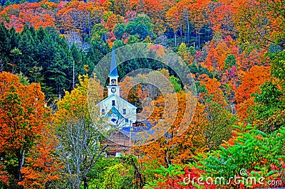 Small white steeple tucked away in the colorful green mountains HDR. Stock Photo