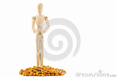 Small wood mannequin with toasted corns on white background Stock Photo