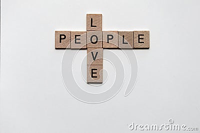 small wood squares with letters creating crossword puzzle spelling words Love people. Stock Photo