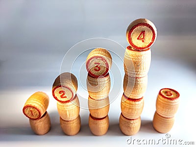 Small wooden barrels with numbers built in columns. The concept of forward movement when achieving the goal and a Stock Photo