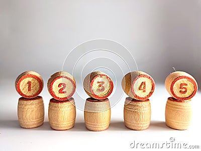 Small wooden barrels with numbers built in a row. The concept of progressive movement in achieving the goal Stock Photo