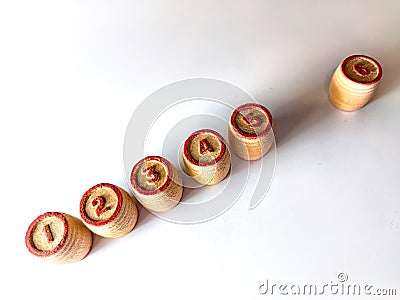 Small wooden barrels with numbers built in a row. The concept of progressive movement in achieving the goal Stock Photo