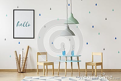 Small wooden chairs and table set for kids and mock-up poster on Stock Photo