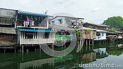 Small wooden houses on canal bank in the city Stock Photo