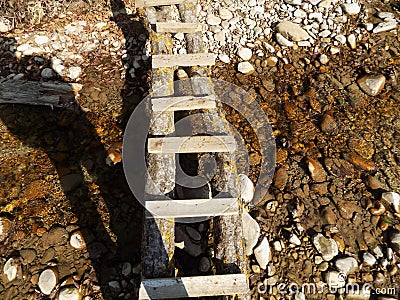 A small wooden ladder-bridge over the river Stock Photo