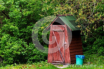 Small wooden outdoors toilet in summer Stock Photo