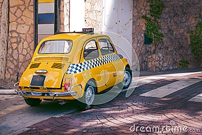 Small yellow classic Italian Retro taxi funny car, travel, tour and tourism, Italy Stock Photo