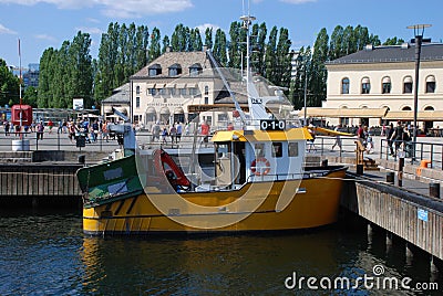 A small yellow fishing boat in Oslo Editorial Stock Photo