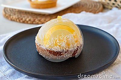 Small yellow lemon ball tart from French pastry shop Stock Photo