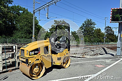 Small yellow tandem vibratory rollers from Caterpillar company used during reconstruction of railway station Editorial Stock Photo