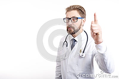 Smart Bearded Brown-haired Doctor Raising Index Finger Stock Photo