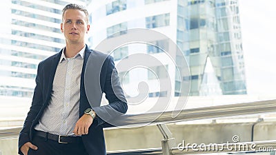 Smart business confident man stand at the outdoor public space Stock Photo