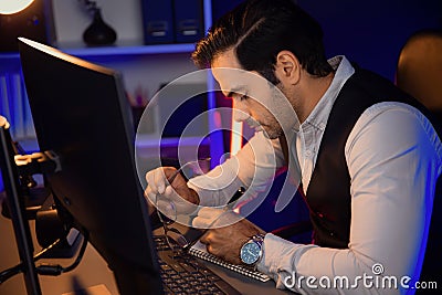 Smart businessman writing memo market data on paper work. Surmise. Stock Photo