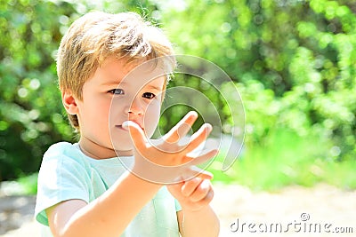 Smart child counts fingers. The boy will be five years old. A beautiful child shows his hand, a small palm. Cute kid on Stock Photo