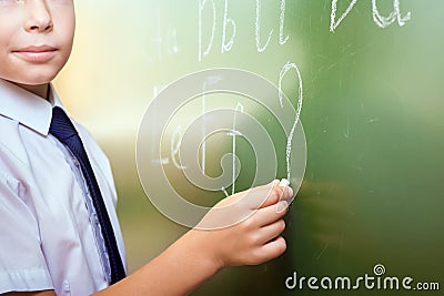 Smart child writing english alphabet Stock Photo