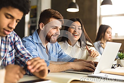 Smart college students networking on laptop in library Stock Photo