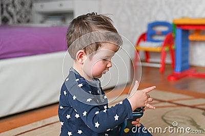 Smart cute child counts fingers. Caucasian boy in pijams on a bedroom background Stock Photo