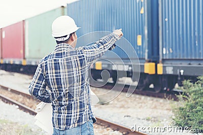 Smart engineer holding white hard hat on hand and look at refinery industry plant at industry factory center area. Asian man Stock Photo