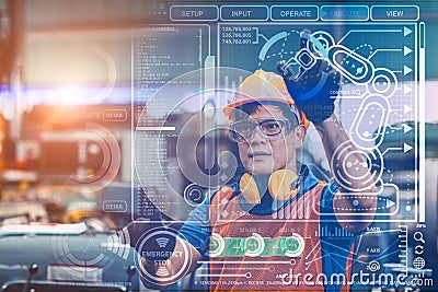 Smart engineer worker using advance technology visual holographic air screen to program and control robotic arm for automated Stock Photo