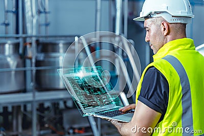 Smart engineer worker using software on laptop to monitor check factory boiler pipe valve control system Stock Photo