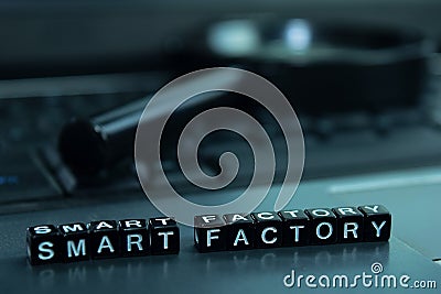 Smart Factory text wooden blocks in laptop background. Business and technology concept Stock Photo